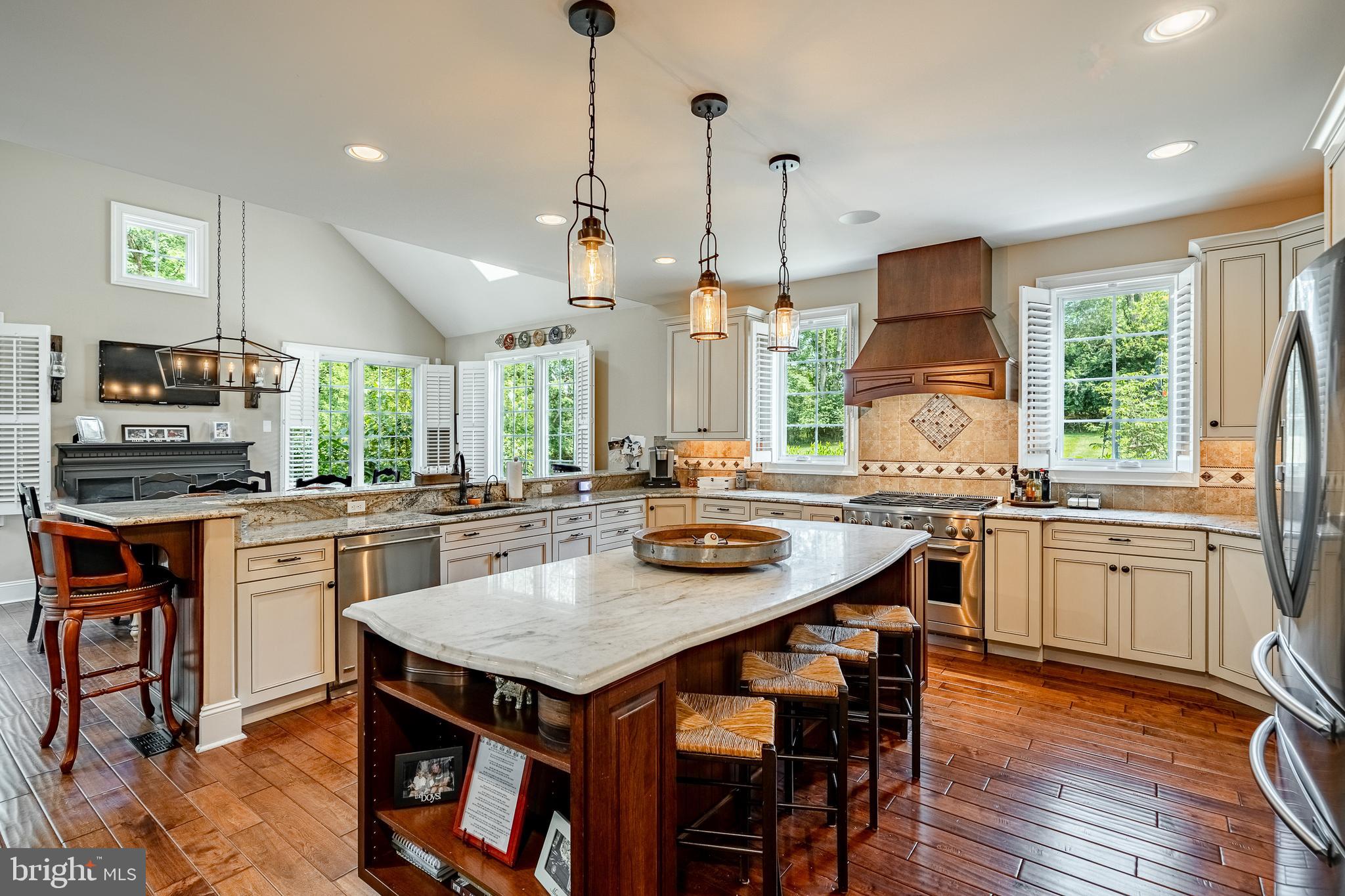 211 Dutton Mill Road West Chester, PA 19380 - Photo 17 of 71 a kitchen with stainless steel appliances granite countertop a stove a sink a microwave a dining table and chairs with wooden floor