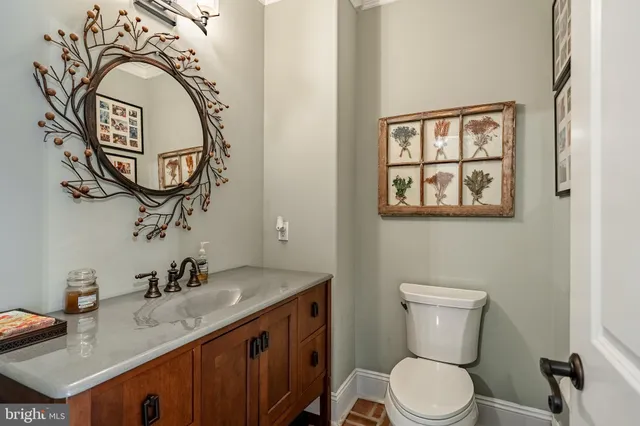 a bathroom with double vanity sinks a toilet a mirror and shower