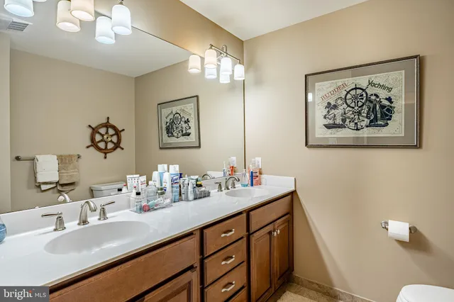 a view of a house with a wooden deck and a yard