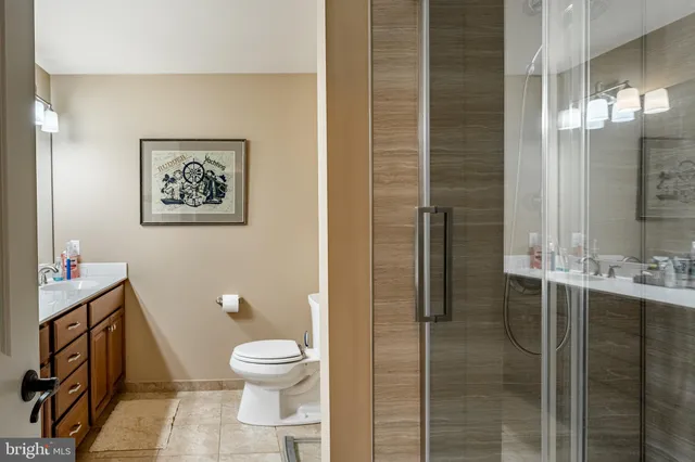 a front view of a house with a garden and trees