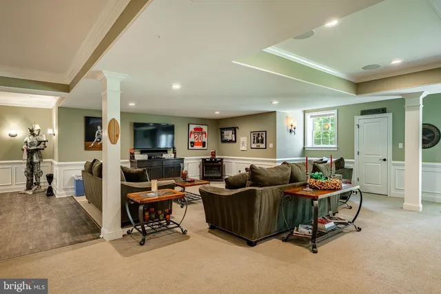 a dining room with wooden floor a chandelier a wooden table and chairs