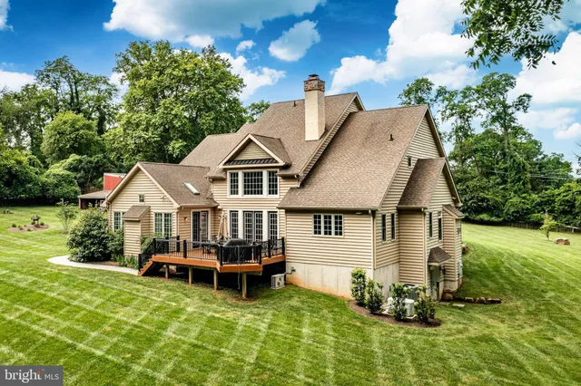 an aerial view of a house with swimming pool and big yard