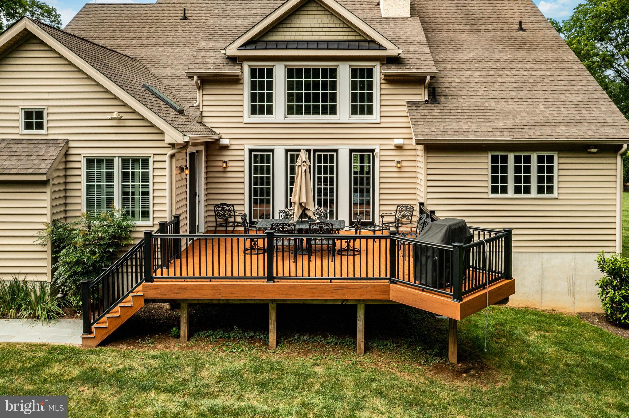 211 Dutton Mill Road West Chester, PA 19380 - Photo 49 of 71 a view of a house with a wooden deck and a yard