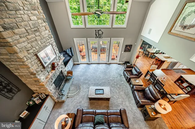 a living room with furniture a large window and potted plants
