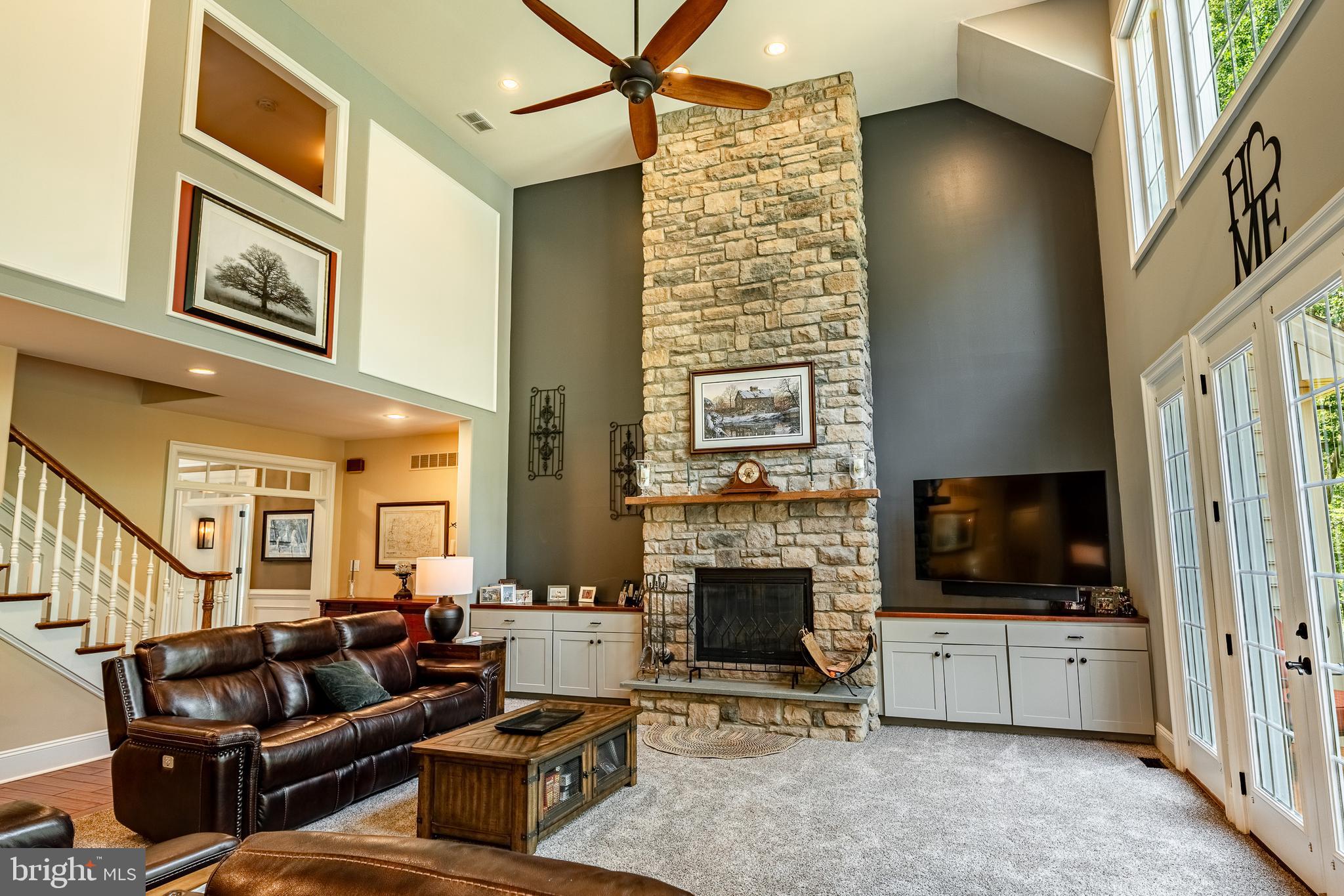 211 Dutton Mill Road West Chester, PA 19380 - Photo 8 of 71 a living room with furniture a flat screen tv and a fireplace