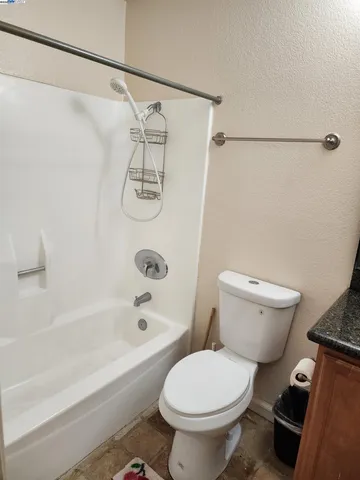 a bathroom with a toilet and a bath tub