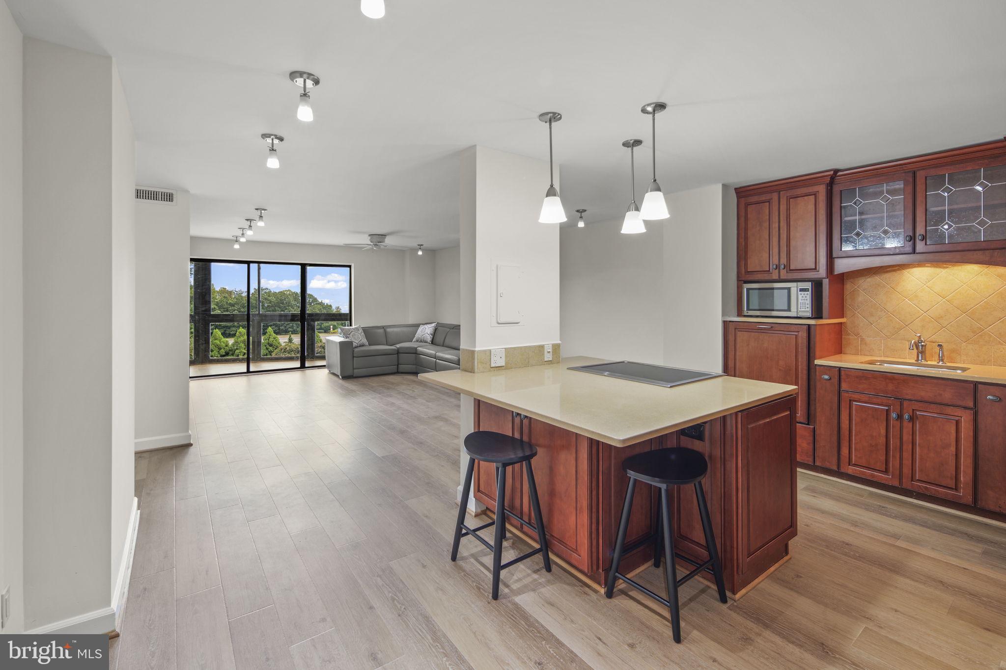 a kitchen with a wooden floor and window