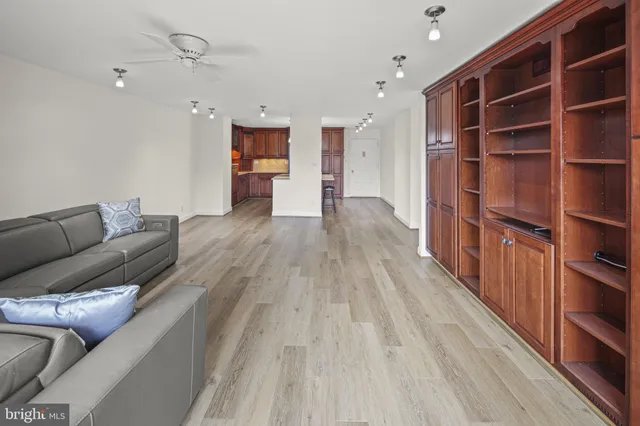 a living room with furniture and a book shelf