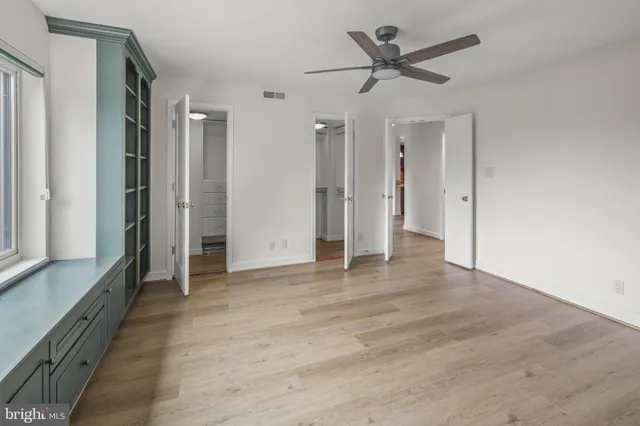a view of an empty room and kitchen view