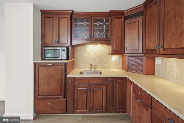 a kitchen with stainless steel appliances granite countertop a refrigerator and cabinets