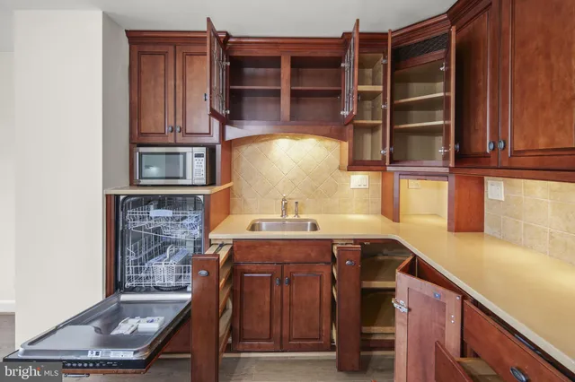 a view of kitchen with cabinets and window