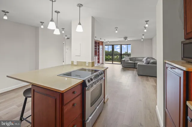 a kitchen with a stove a counter space a sink and a fireplace