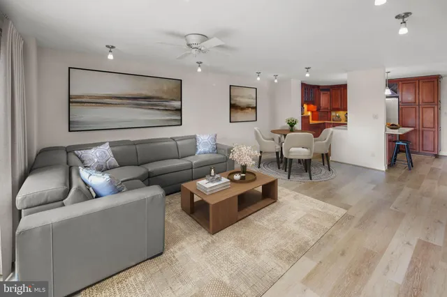 a living room with furniture and wooden floor