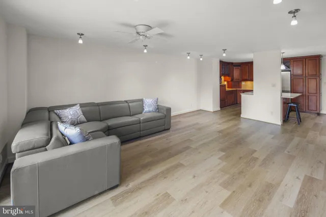 a living room with furniture and wooden floor