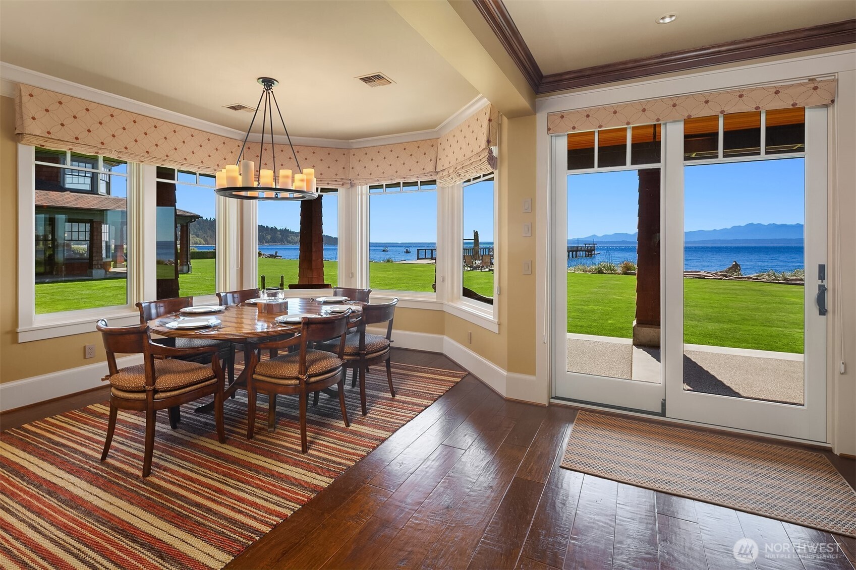 5844 Mutiny Bay Road Freeland, WA 98249 - Photo 17 of 40 a view of a dining room with furniture window and wooden floor