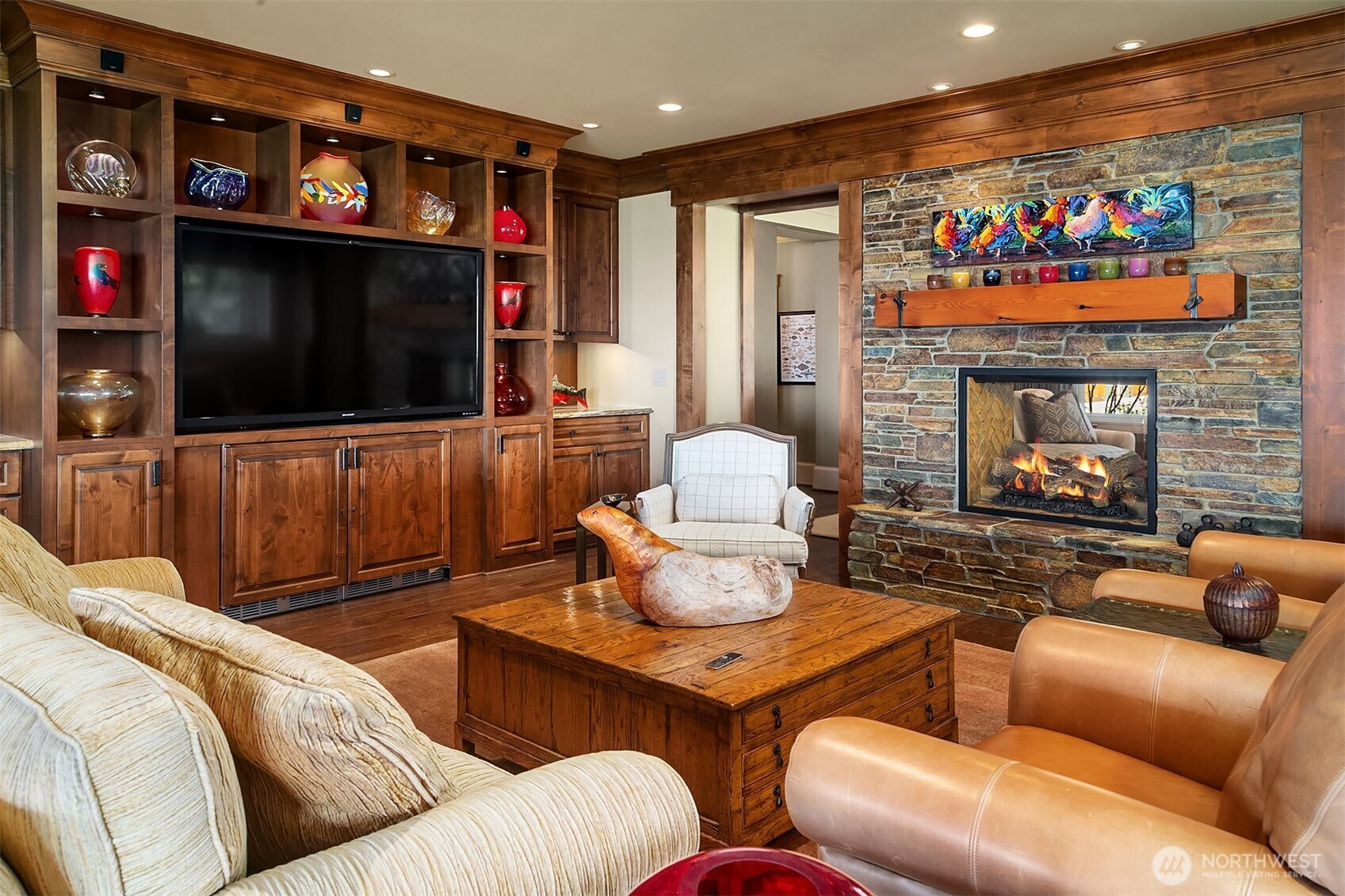5844 Mutiny Bay Road Freeland, WA 98249 - Photo 20 of 40 a living room with furniture a flat screen tv and a fireplace