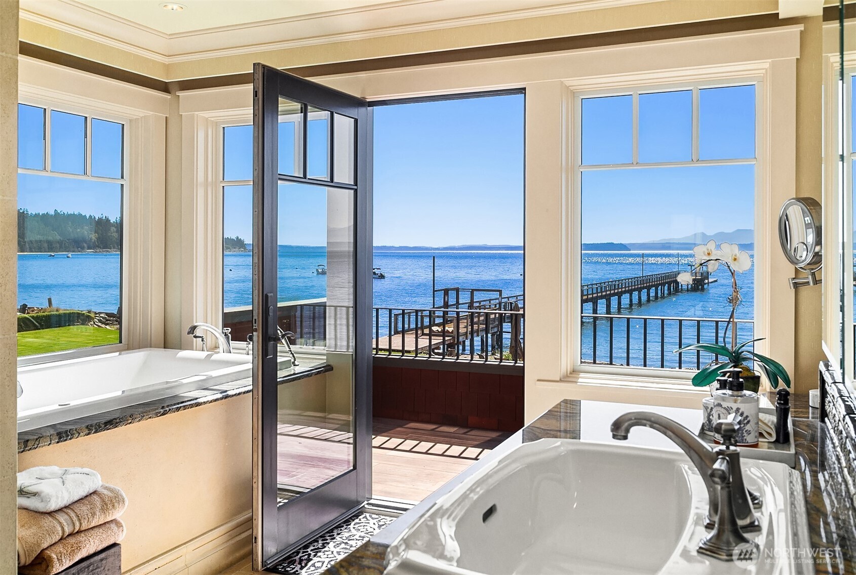5844 Mutiny Bay Road Freeland, WA 98249 - Photo 25 of 40 a bathroom with a tub and a large window