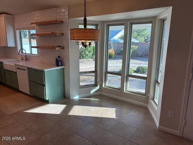 a room with a large window and kitchen view