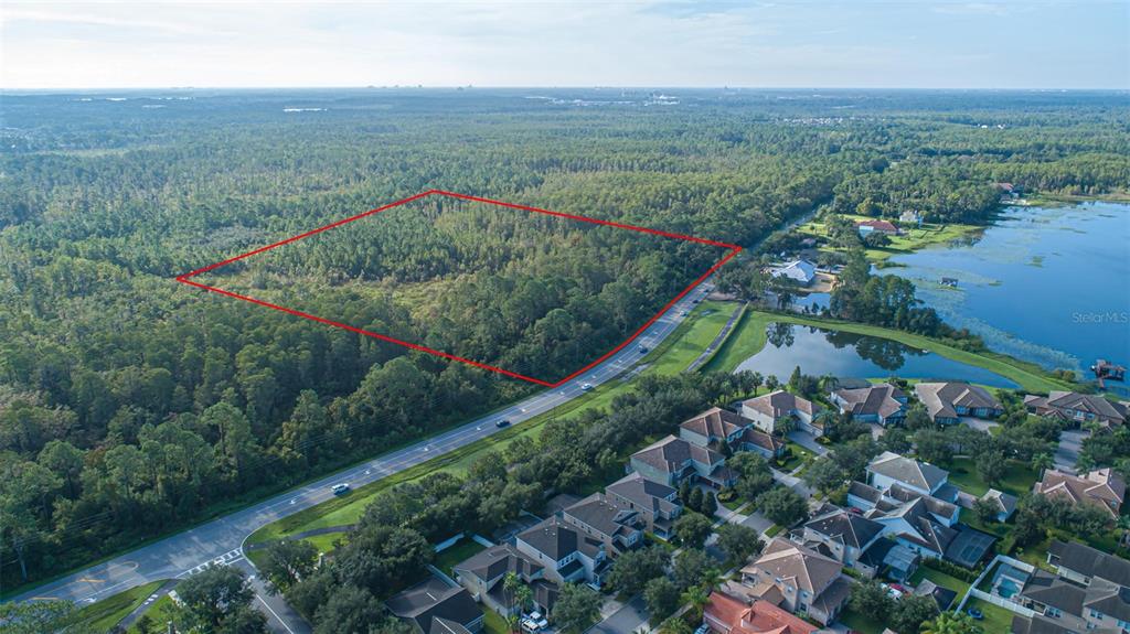 7545 Ficquette Road Windermere, FL 34786 - Photo 9 of 23 an aerial view of green landscape with trees houses and mountain view