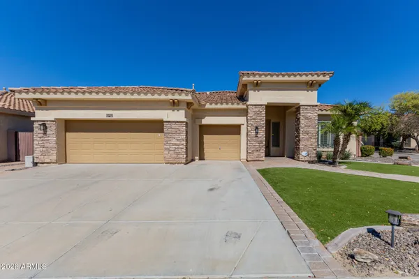 a front view of a house with a yard and garage