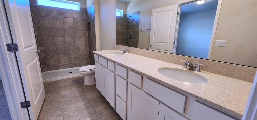 3538 Treetop Street DeLand, FL 32724 - Photo 6 of 7 a bathroom with a granite countertop sink a toilet and shower