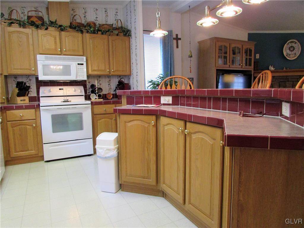 648 Old Mill Road Lehighton, PA 18235 - Photo 22 of 48 a kitchen with stainless steel appliances granite countertop a sink a stove and a refrigerator