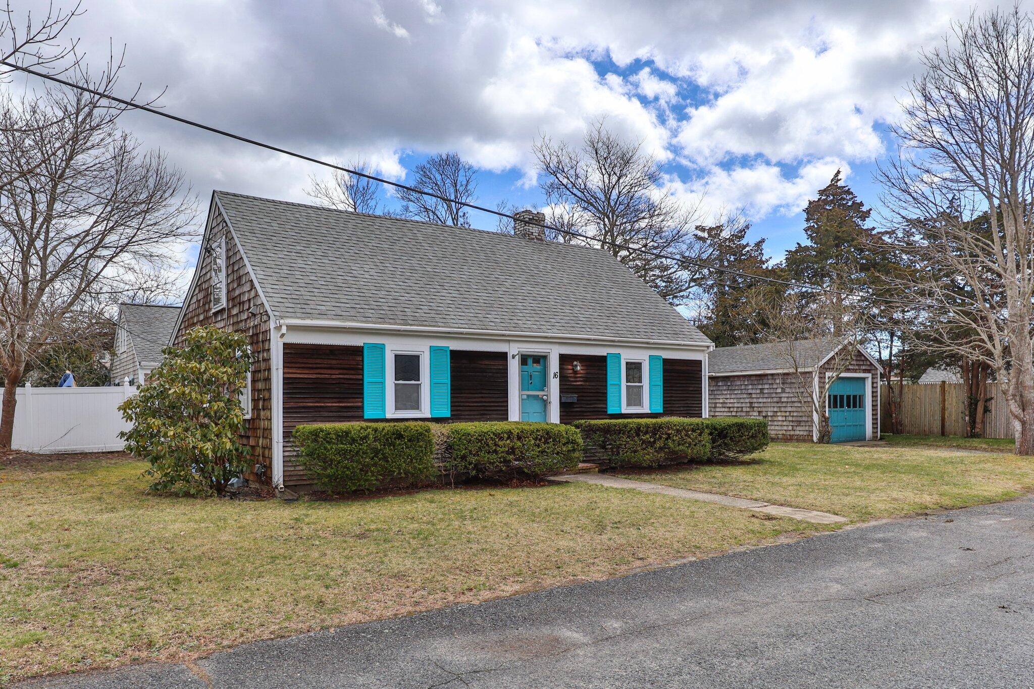 16 Oak Street Hyannis, MA 02601 - Photo 1 of 38 a front view of house with yard and trees around