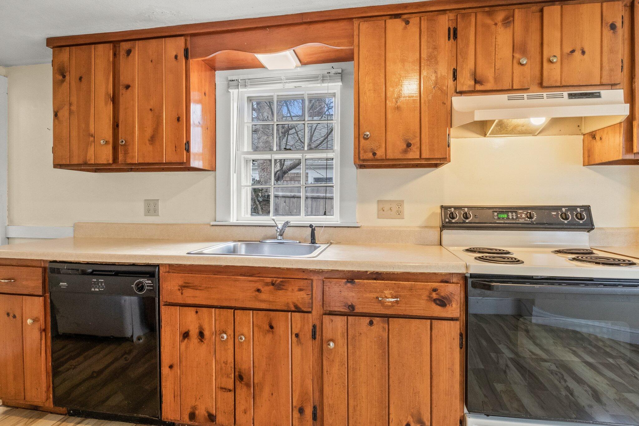 16 Oak Street Hyannis, MA 02601 - Photo 11 of 38 a kitchen with stainless steel appliances granite countertop a sink and a stove
