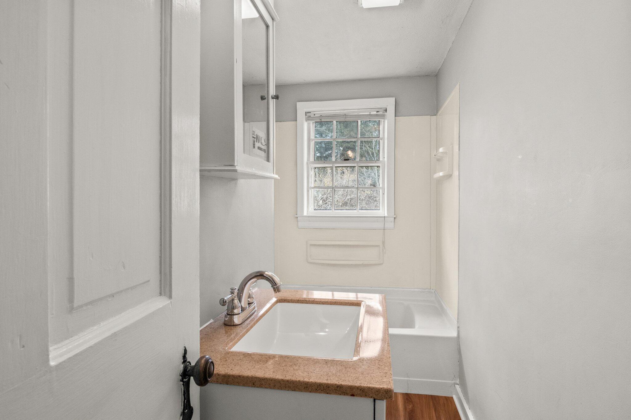 16 Oak Street Hyannis, MA 02601 - Photo 14 of 38 a bathroom with a sink toilet and window