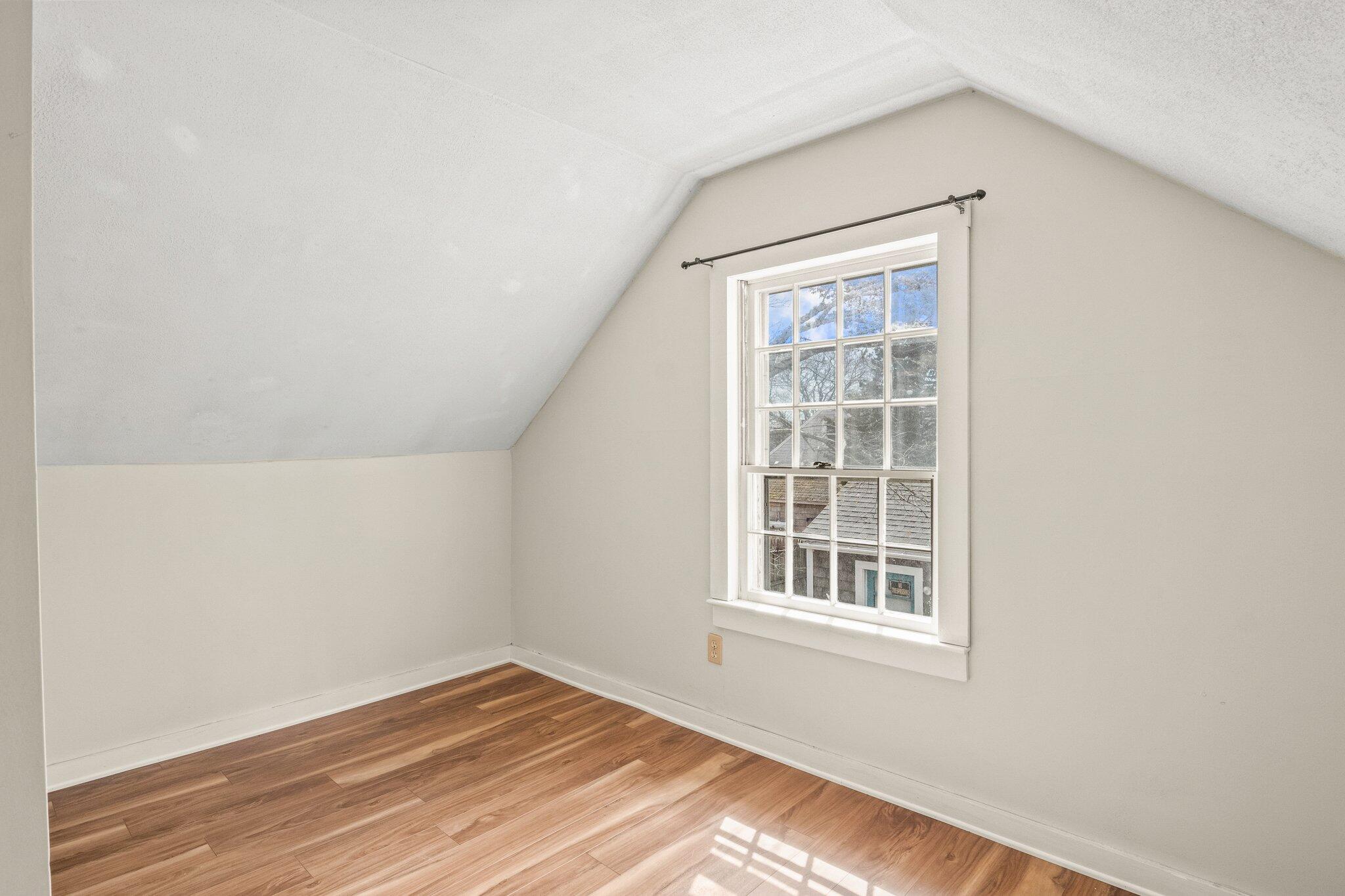 16 Oak Street Hyannis, MA 02601 - Photo 20 of 38 a view of an empty room with wooden floor and a window