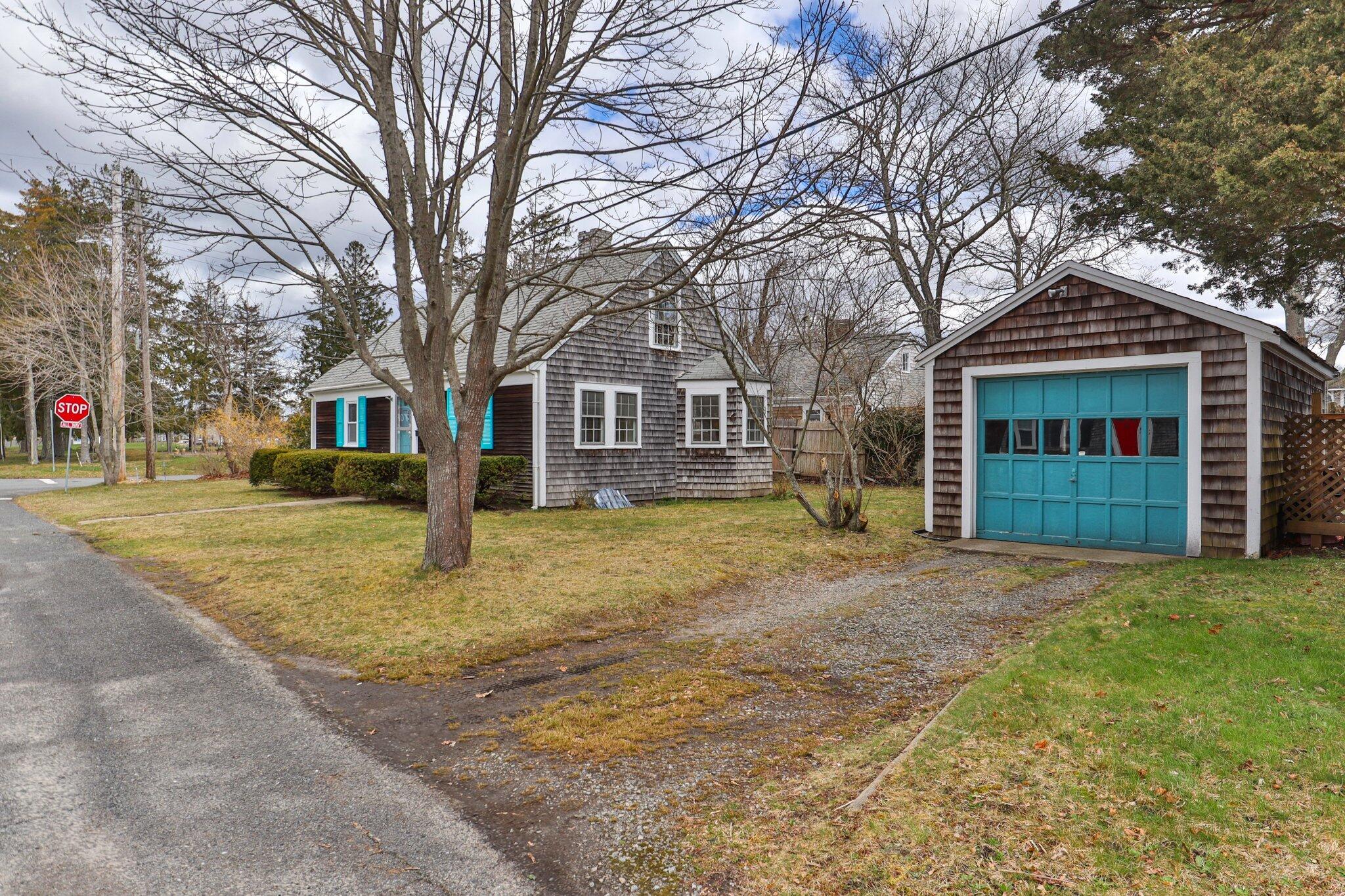 16 Oak Street Hyannis, MA 02601 - Photo 2 of 38 a front view of a house with a yard and garage