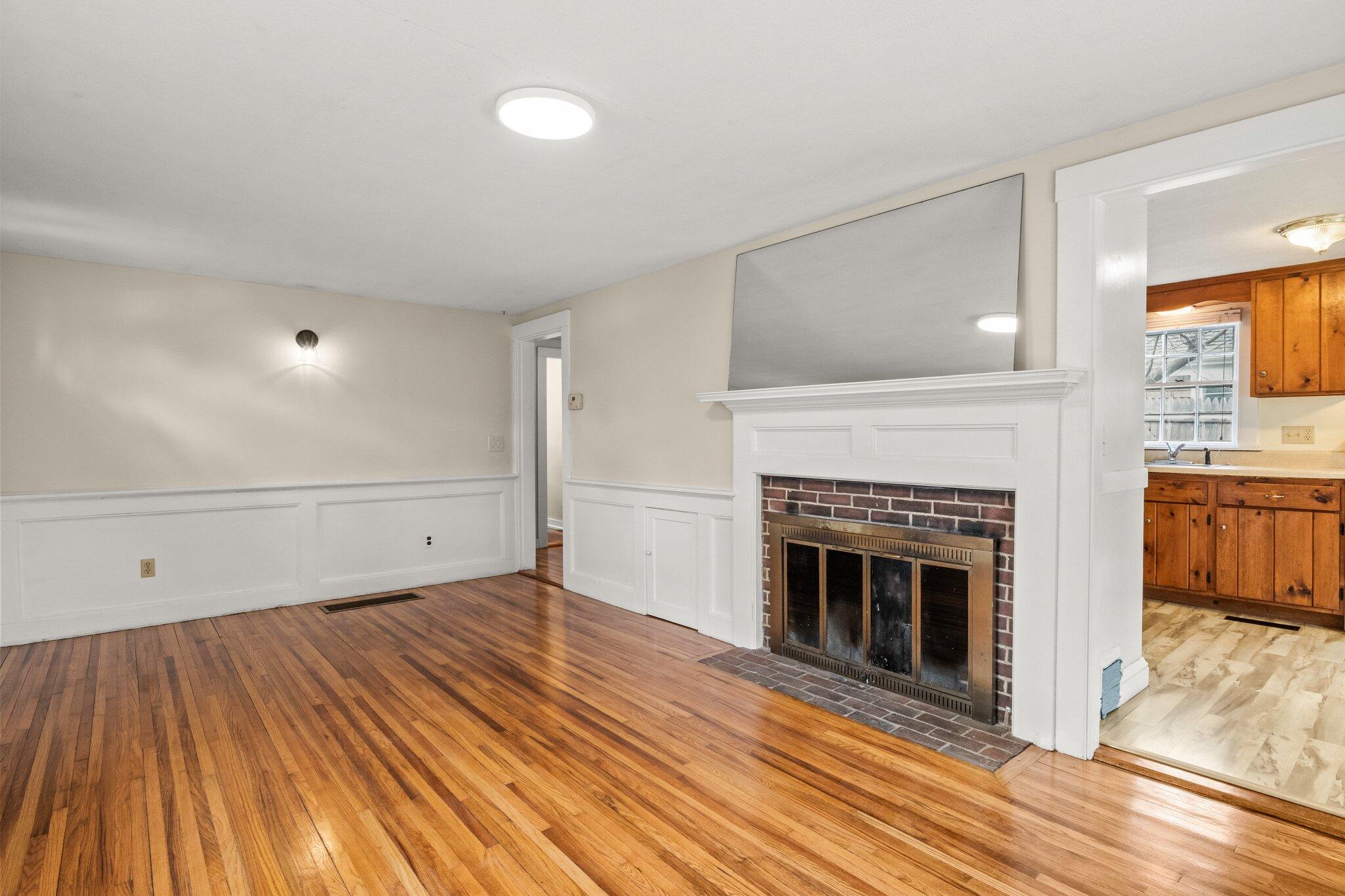 16 Oak Street Hyannis, MA 02601 - Photo 9 of 38 a view of a livingroom with wooden floor and a fireplace
