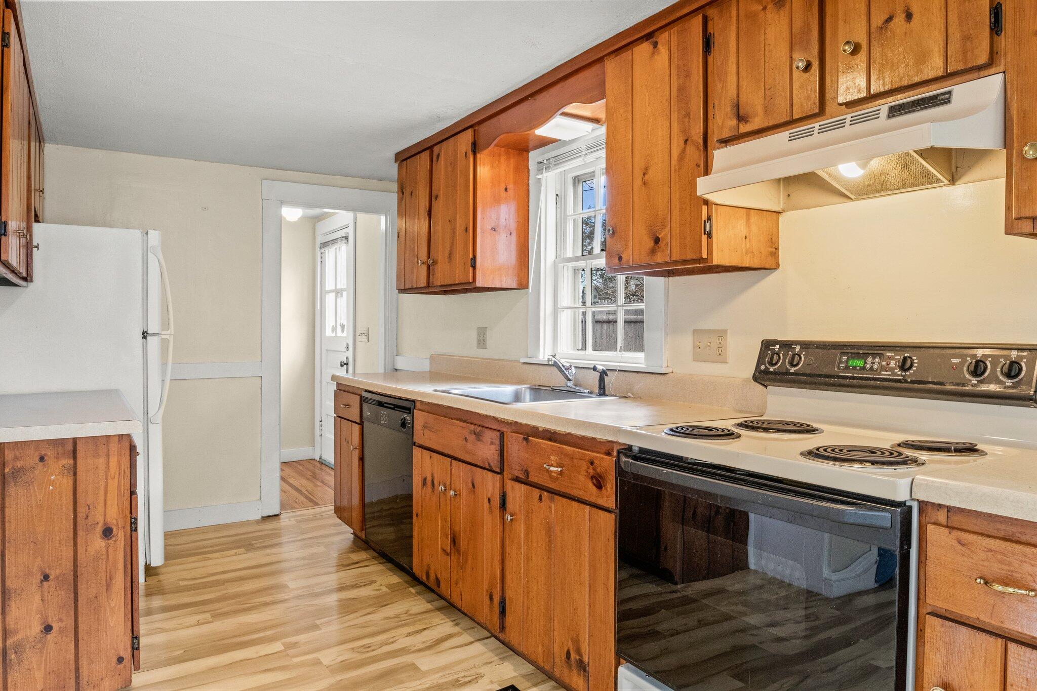 16 Oak Street Hyannis, MA 02601 - Photo 10 of 38 a kitchen with stainless steel appliances granite countertop a stove and a sink