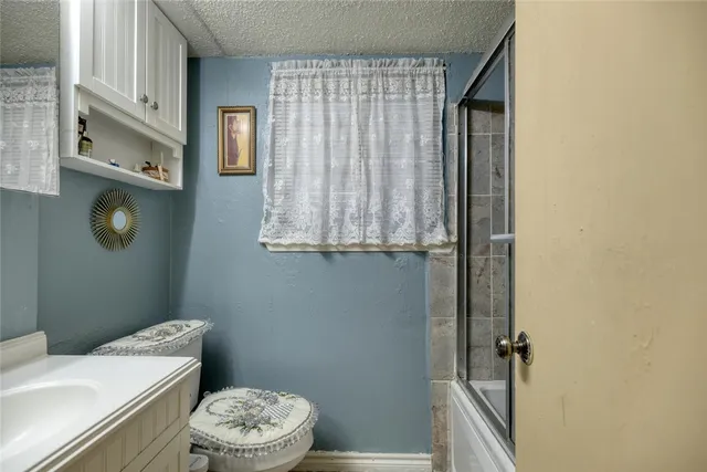 a bathroom with a toilet a sink and tub
