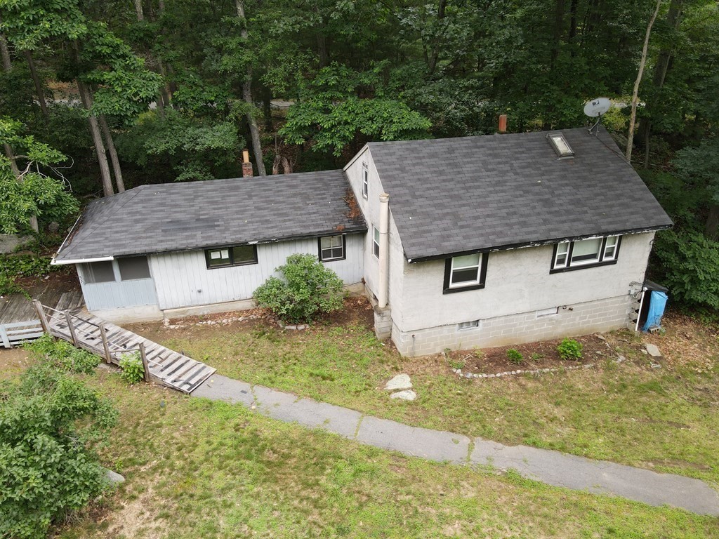 a aerial view of a house with a yard and garage
