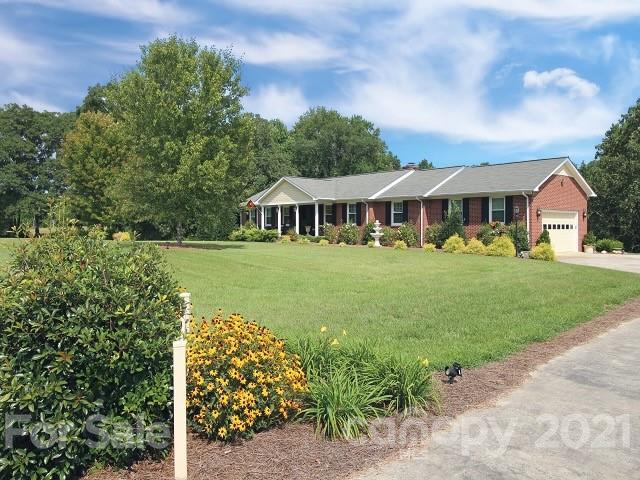 4622 Edgeland Road Edgemoor, SC 29712 - Photo 1 of 29 a view of a white house with a big yard and potted plants