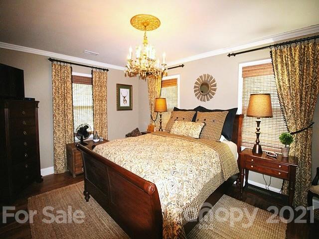 4622 Edgeland Road Edgemoor, SC 29712 - Photo 13 of 29 a bedroom with a bed and a chandelier