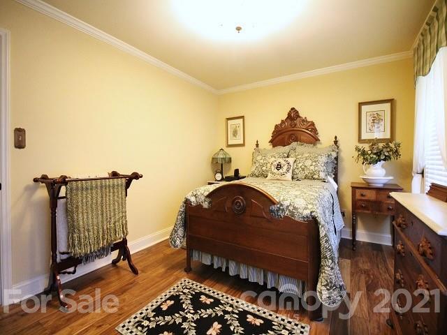 4622 Edgeland Road Edgemoor, SC 29712 - Photo 15 of 29 a bedroom with a bed and wooden floor