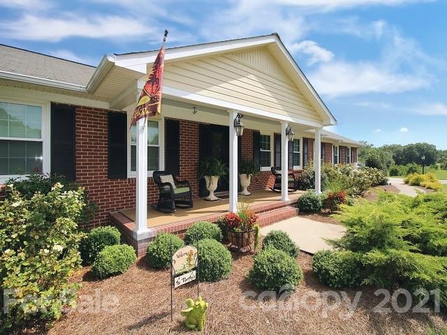 4622 Edgeland Road Edgemoor, SC 29712 - Photo 4 of 29 a view of a house with potted plants and a large tree