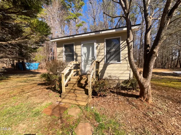 a view of a backyard with a large tree