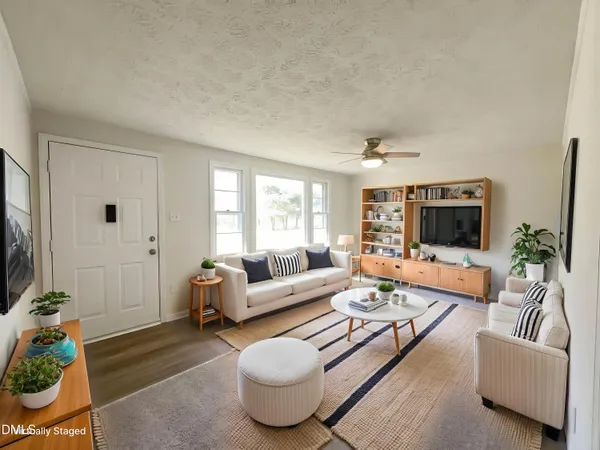 a living room with furniture and a flat screen tv