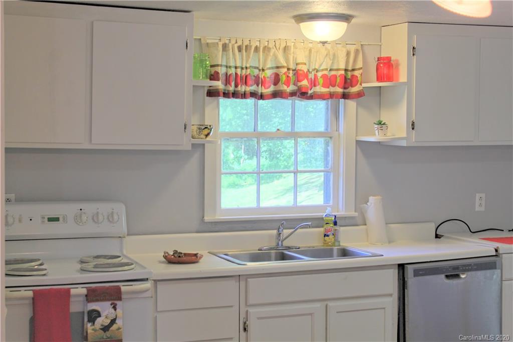 128 Murray Road Canton, NC 28716 - Photo 3 of 29 a kitchen with stainless steel appliances granite countertop a sink stove and cabinets