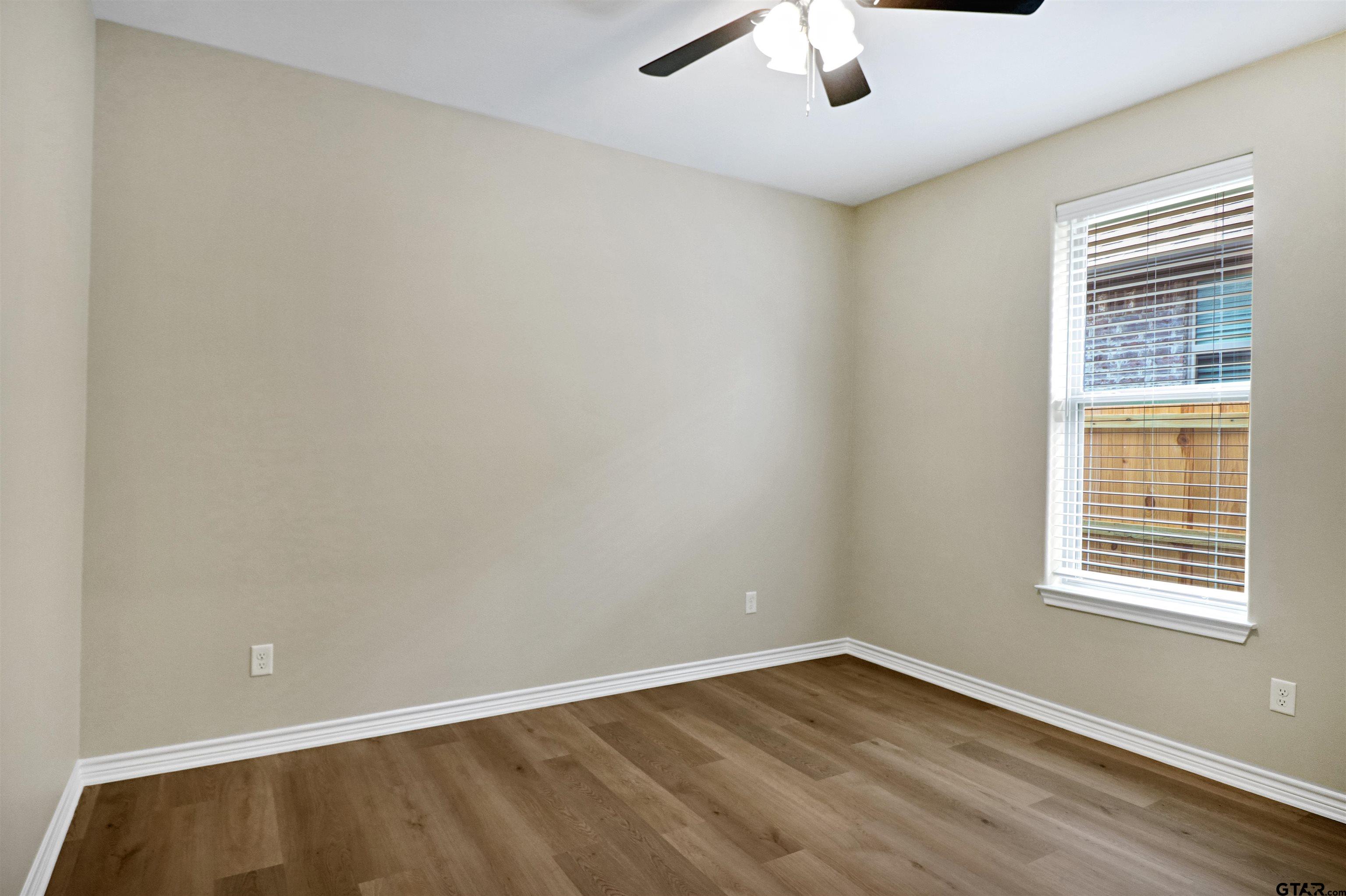 3053 Guinn Farms Road Tyler, TX 75707 - Photo 26 of 32 wooden floor in an empty room with a window