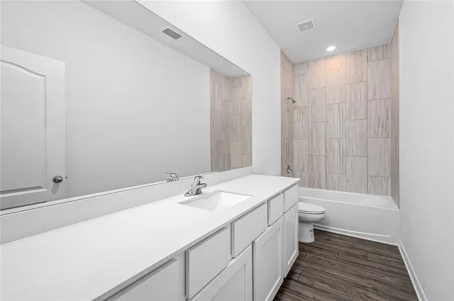 a bathroom with a double vanity sink toilet and shower