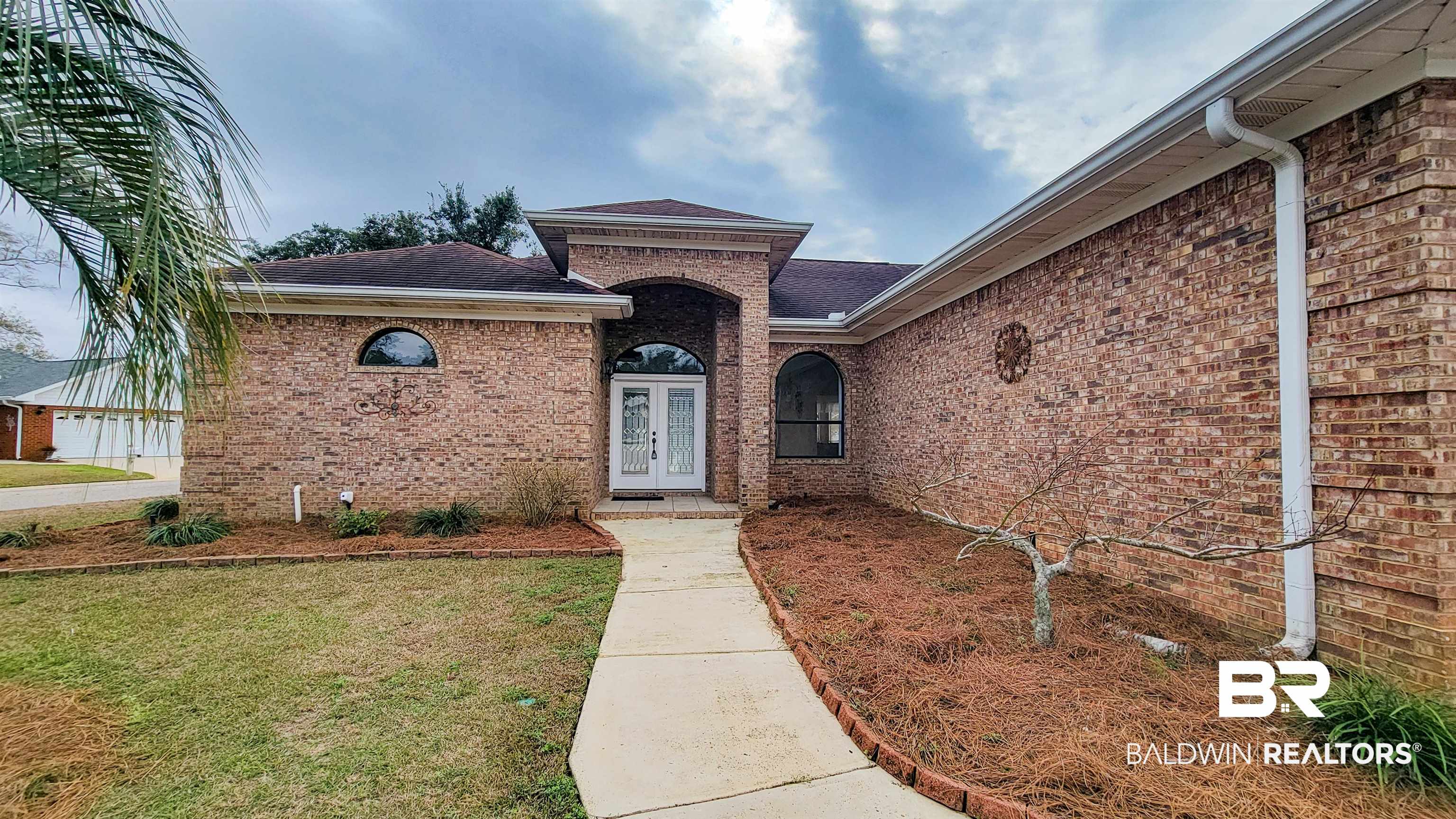 214 Hemingway Loop Foley, AL 36535 - Photo 1 of 67 Entrance to property featuring a lawn, a shingled roof, and brick siding