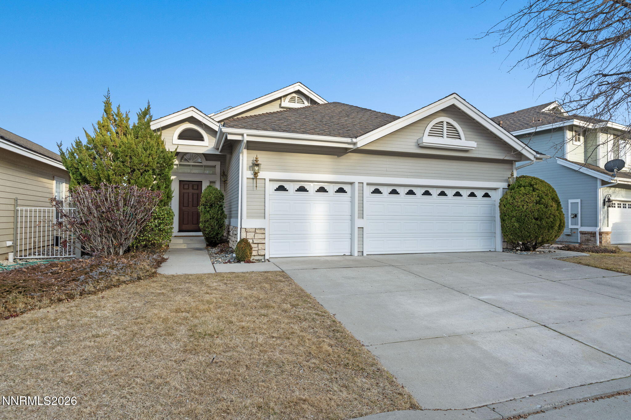 6186 Squires Lane Reno, NV 89519 - Photo 55 of 57 a front view of a house with a yard and garage