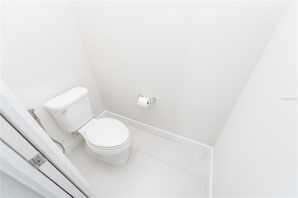 10746 Pahokee Beach Place Orlando, FL 32827 - Photo 21 of 67 a white toilet sitting next to a white wall