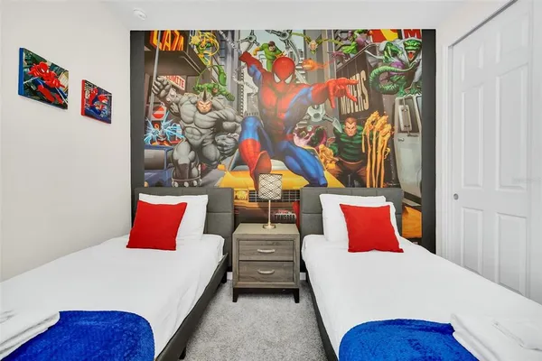 a bedroom with a bed and a painting on the wall