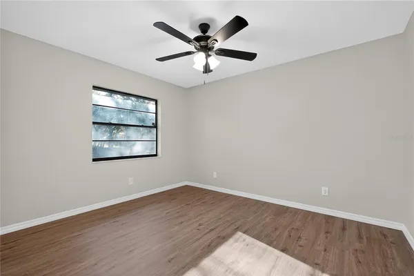 a view of an empty room with wooden floor