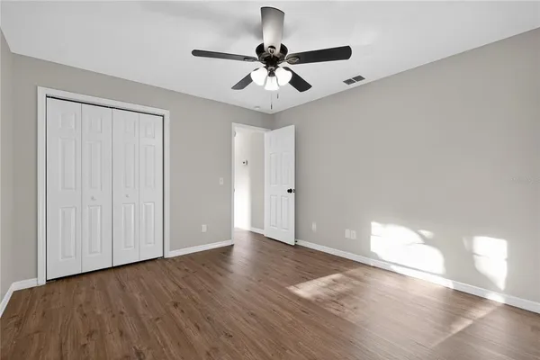 a view of a kitchen with a sink and dishwasher with wooden floor